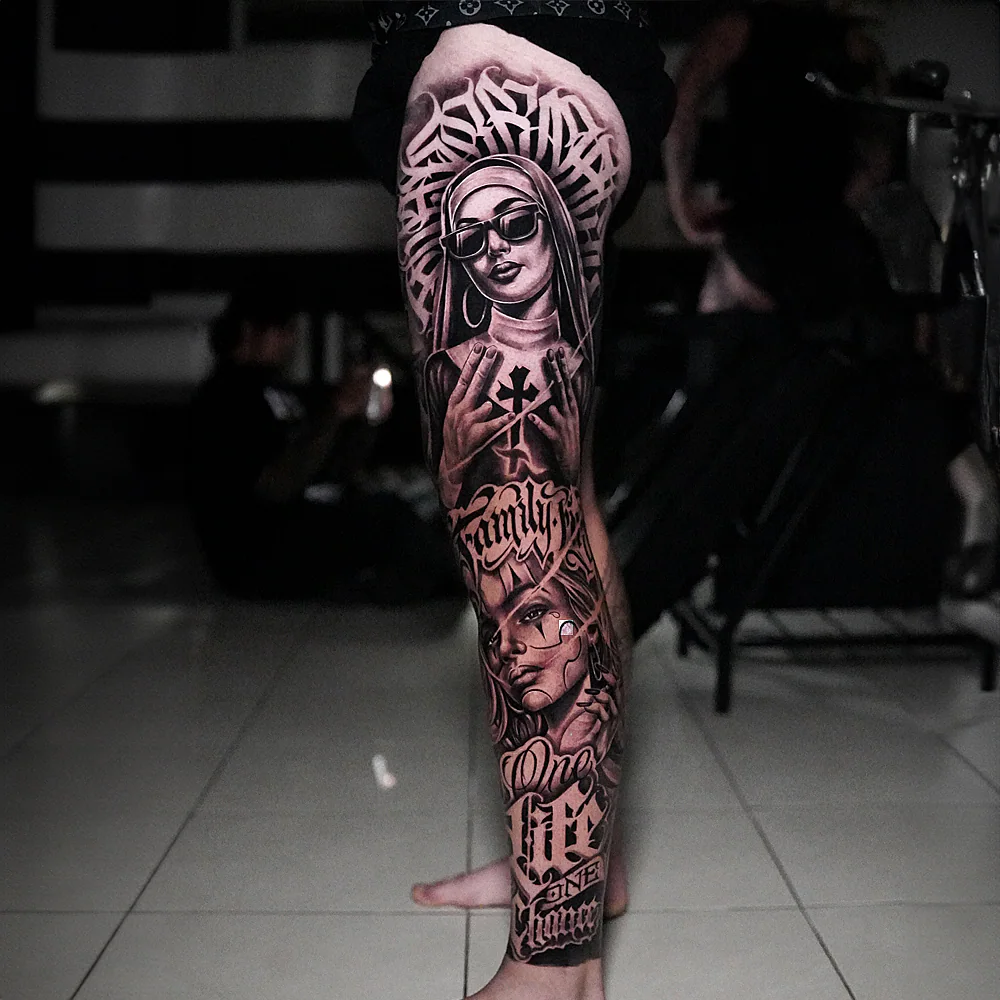 Black and grey leg sleeve tattoo with nun portrait and chicano lettering
